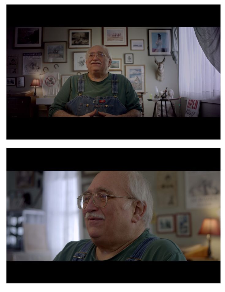 an older man with glasses sitting in front of a window