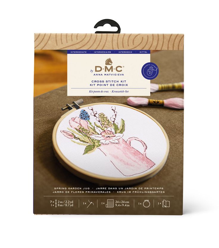 a cross stitch kit with an embroidery pattern on it and the package in front of it