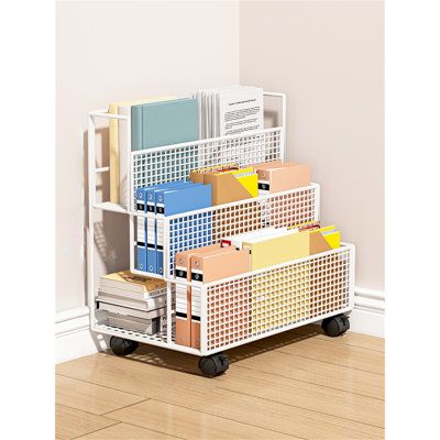 a stack of boxes sitting on top of a wooden floor next to a white wall