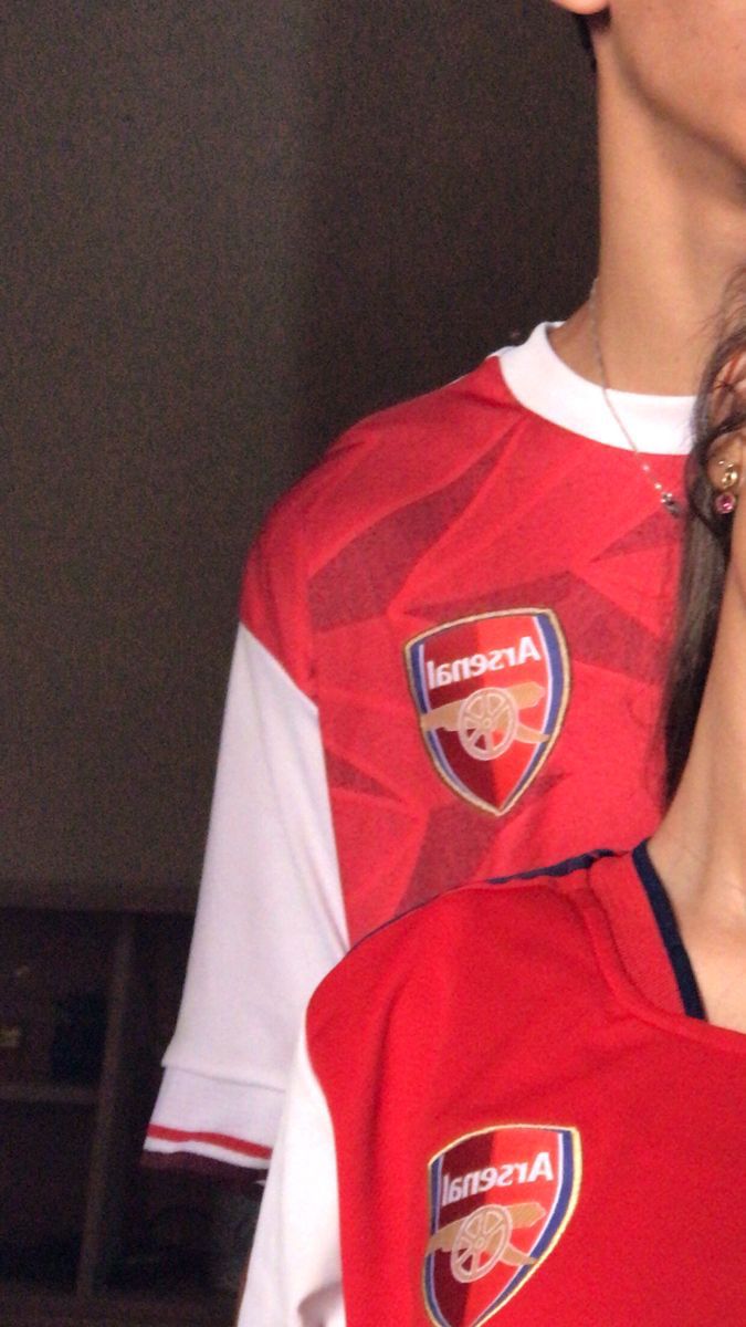 a young man in a red and white soccer uniform