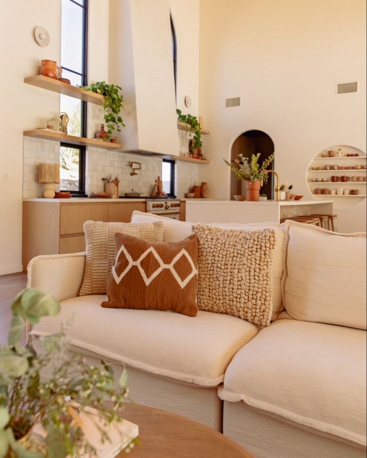 a living room filled with furniture and lots of windows