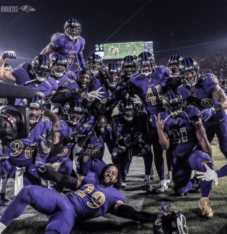 a group of football players standing on top of a field