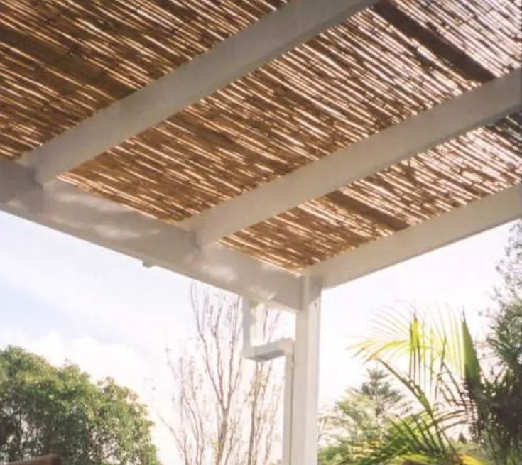 an outdoor covered patio with chairs and tables