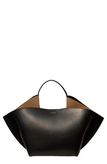 Defined by a freeform-sculpture silhouette and smooth calfskin leather, this Italian-made tote from Amsterdam-based designer Desiree Kleinen quietly impresses. The fluidly folded design provides ample carrying capacity, and the runner-reinforced base keeps everything on an even keel. Magnetic closure Top carry handle Structured silhouette with flat base for stability Leather Made in Italy Designer Handbags Black Owned and Founded Fashion Job, Modern Handbag, Investment Bags, Fashion Jobs, Handbags Black, All Black Fashion, Oversized Tote Bag, Wholesale Bags, Fabric Gift Bags