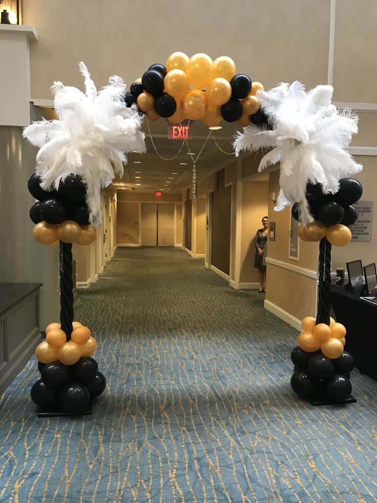 an entrance decorated with balloons and streamers for a party or event in the hallway