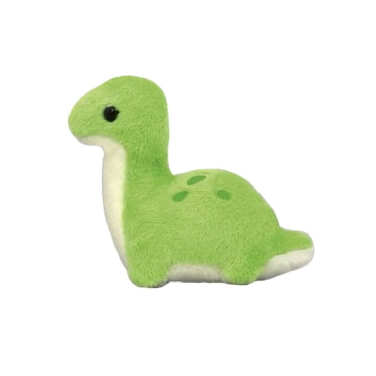 a green stuffed animal sitting on top of a white surface