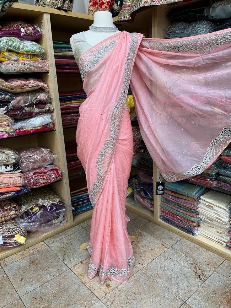 Light Pink georgette embroidered with crystal work saree with unstitched blouse. Fabric: Georgette Ready to Ship! Embellished Pink Blouse Piece For Eid, Pink Party Wear Saree For Festive Occasions, Pink Party Wear Saree For Festive Season, Festive Pink Party Wear Saree, Pink Party Wear Pre-draped Saree With Mirror Work, Semi-stitched Pink Party Wear Saree, Pink Dola Silk Dupatta For Party Wear, Pink Party Wear Saree Blouse Piece, Embellished Pink Silk Traditional Wear