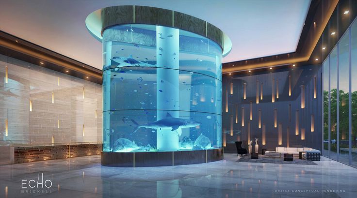 a large aquarium in the middle of a building with lights on it's sides