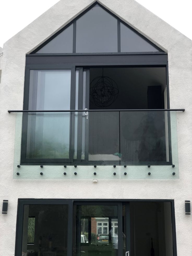 a white building with black glass doors and windows