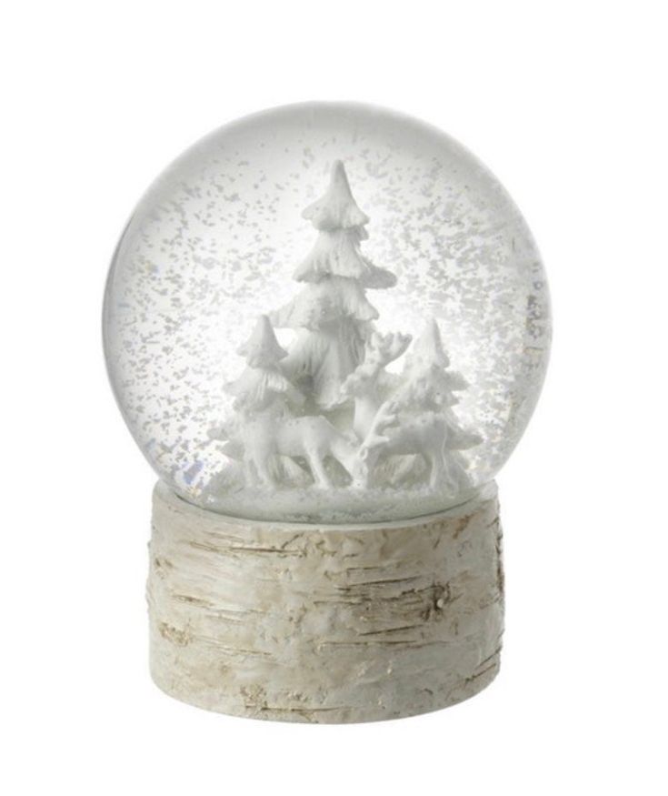 a snow globe with trees and animals in it