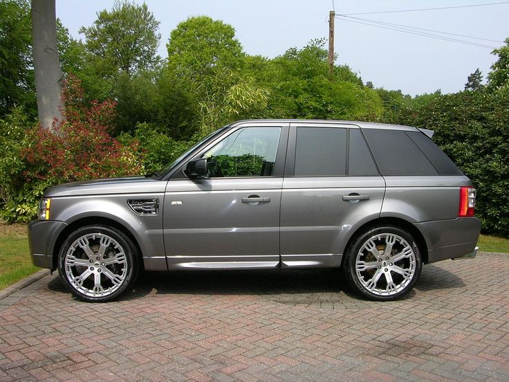 a silver range rover parked on a brick driveway