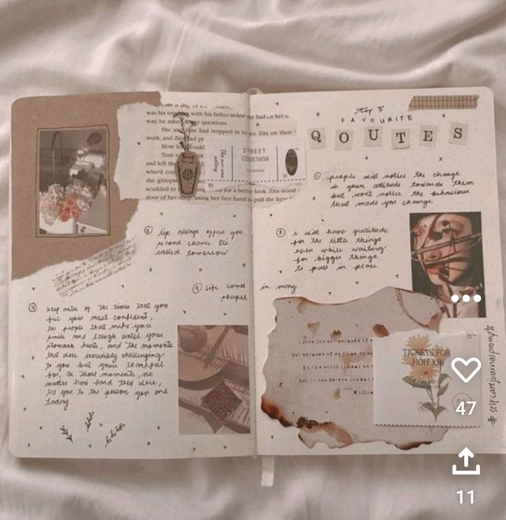 an open book with pictures and writing on it sitting on a white sheet covered bed