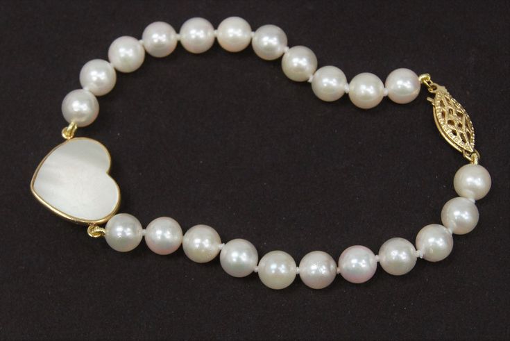 "Akoya Cultured Pearl Strand Bracelet with Mabe Pearl Heart Pearl Size: 6mm- 6.5mm Pearl Color: Cream with Rose overtone Clasp Type: Fishhook Clasp Metal: 14K Yellow Gold Length of Bracelet: 7\" Weight: 9.3 grams Newly Restrung. Pre-owned but Good used Condition. Shows signs of use. (B2283)" Elegant Single Strand Jewelry For Valentine's Day, Classic Round Heart Bracelet For Valentine's Day, Classic Round Heart Bracelet For Formal Occasions, Elegant Heart Bracelet With Round Beads For Valentine's Day, White Heart Bracelet For Formal Occasions, Elegant Heart Bracelet For Valentine's Day, Elegant White Heart Bracelet For Formal Occasions, Elegant Pearl Bracelet For Valentine's Day, White Heart-shaped Bracelet For Formal Occasions