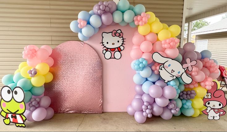 hello kitty balloon arch with balloons on it