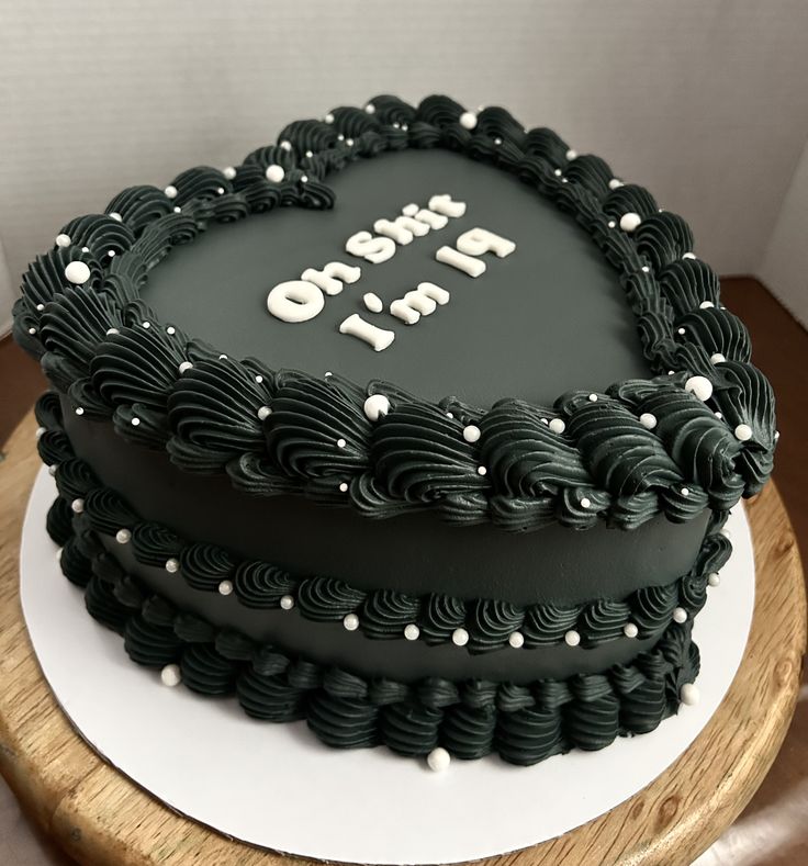 there is a black cake with white frosting on the top that says oh no to it