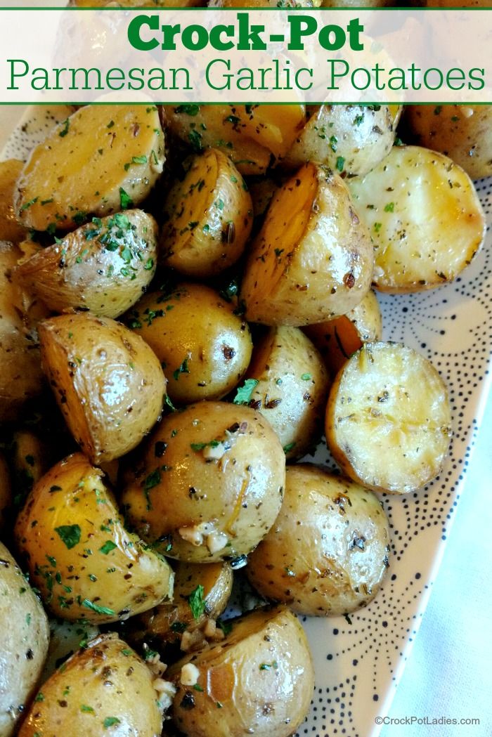 a plate full of cooked potatoes with parmesan garlic on the side and text overlay that reads crock - pot parmesan garlic potatoes