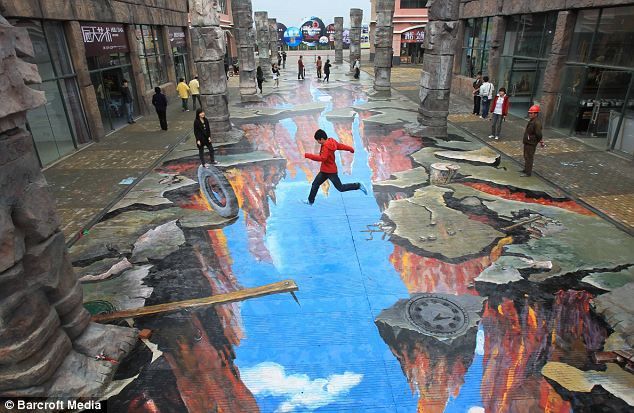 a person jumping in the air on a street painted with blue and red paint,