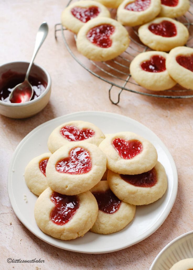 heart shaped cookies on a plate with jam