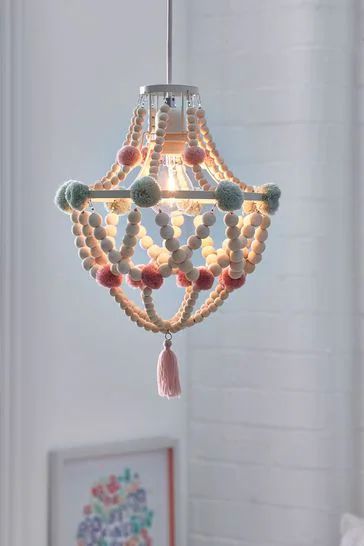 a chandelier with beads and tassels hanging from the ceiling