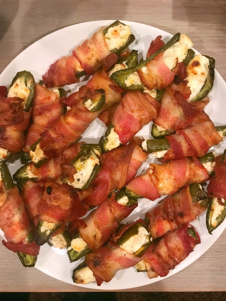 bacon wrapped jalapenos on a white plate