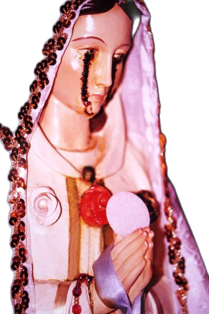 a statue of the virgin mary holding a lollipop