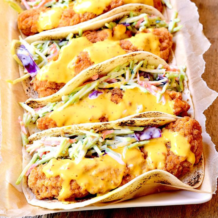 chicken tacos with cole slaw and mustard on top