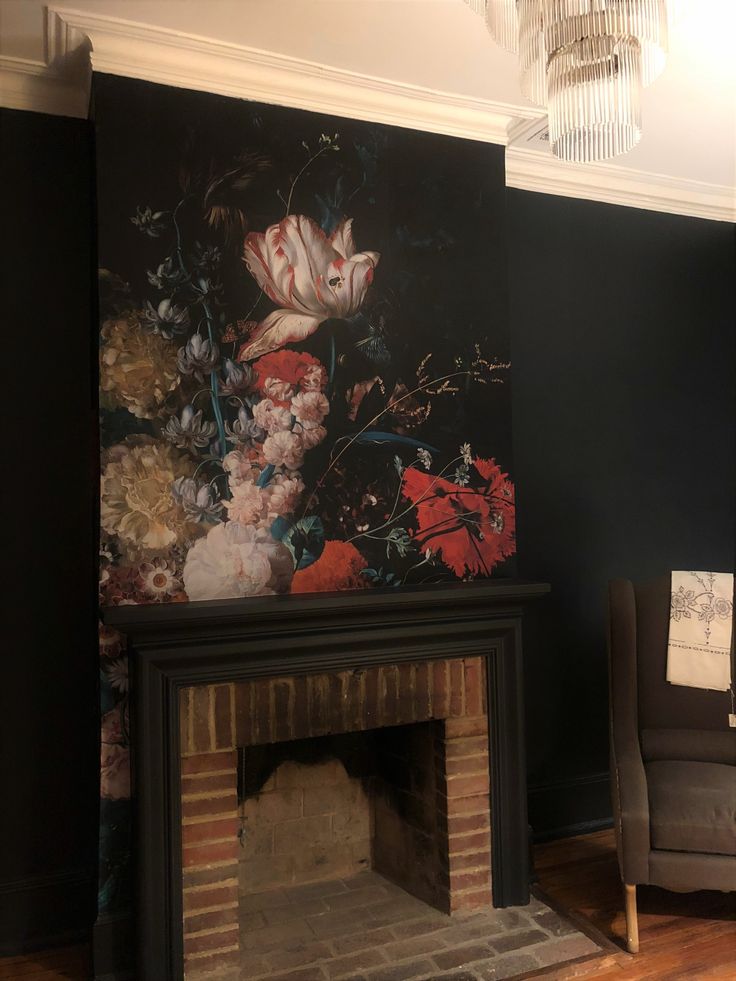 a living room with a fire place and painting on the wall