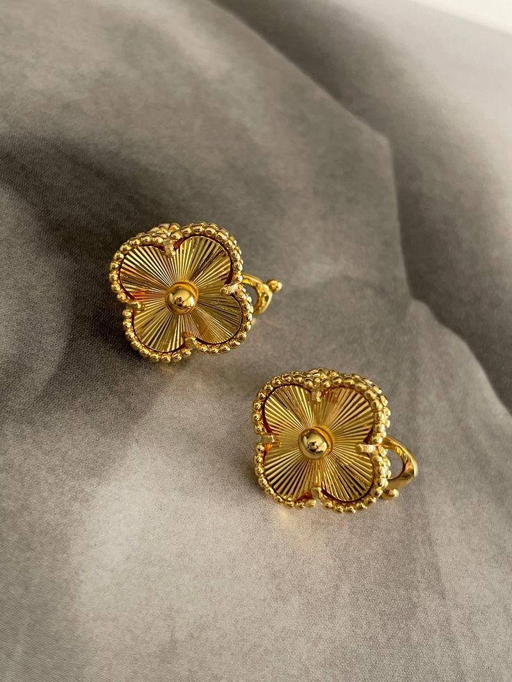 The Clover Earrings bring a classic touch of style to any look. Show off your beautiful earrings with their timeless clover design for an instantly chic style. Elegant Gold Flower Earrings Nickel Free, Elegant Hypoallergenic Flower-shaped Earrings, Elegant Hypoallergenic Flower Shaped Earrings, Elegant Clip-on Drop Flower Earrings, Elegant Round Hypoallergenic Flower Earrings, Elegant Hypoallergenic Round Flower Earrings, Elegant Flower Shaped Hypoallergenic Earrings, Vintage Gold Earrings With Flower Charm, Gold Clip-on Earrings In Flower Shape