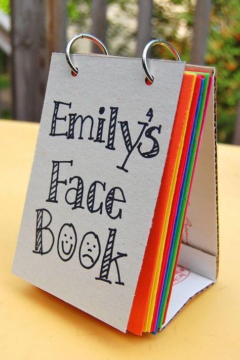 a close up of a small book on a table with paper clippings attached to it