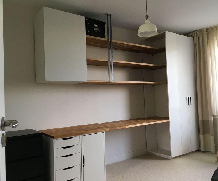 an empty room with some shelves and drawers