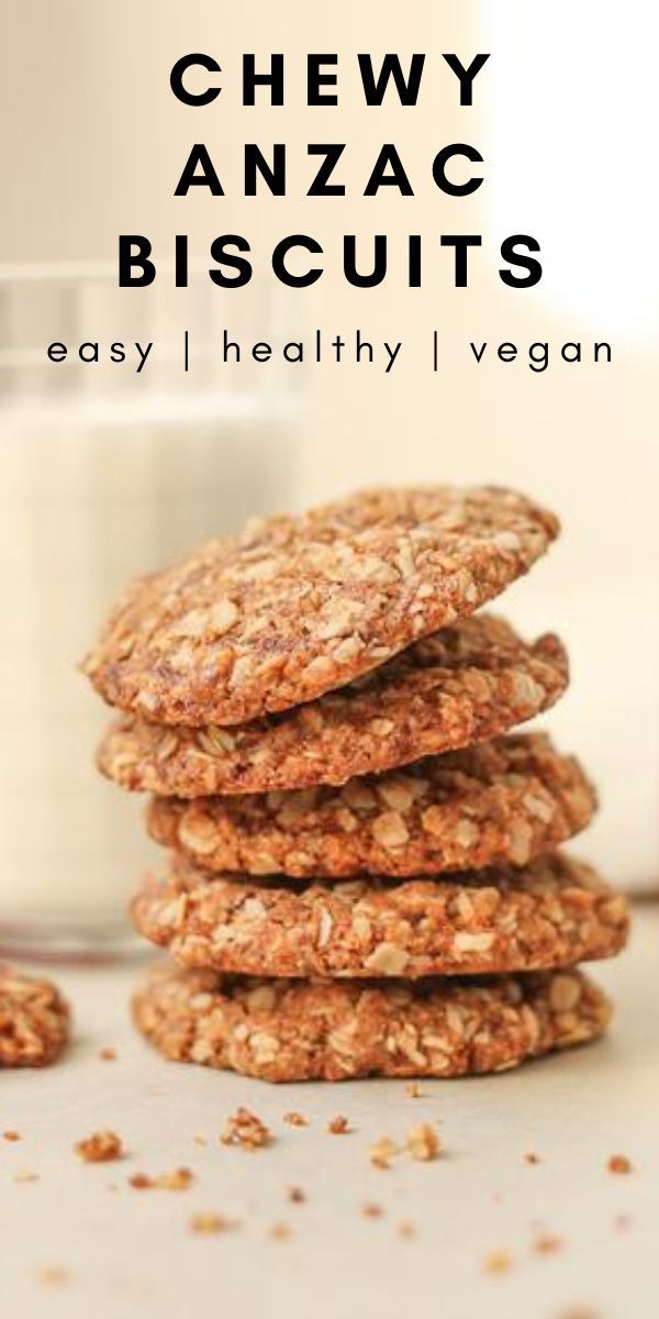 chewy anzac biscuits stacked on top of each other next to a glass of milk