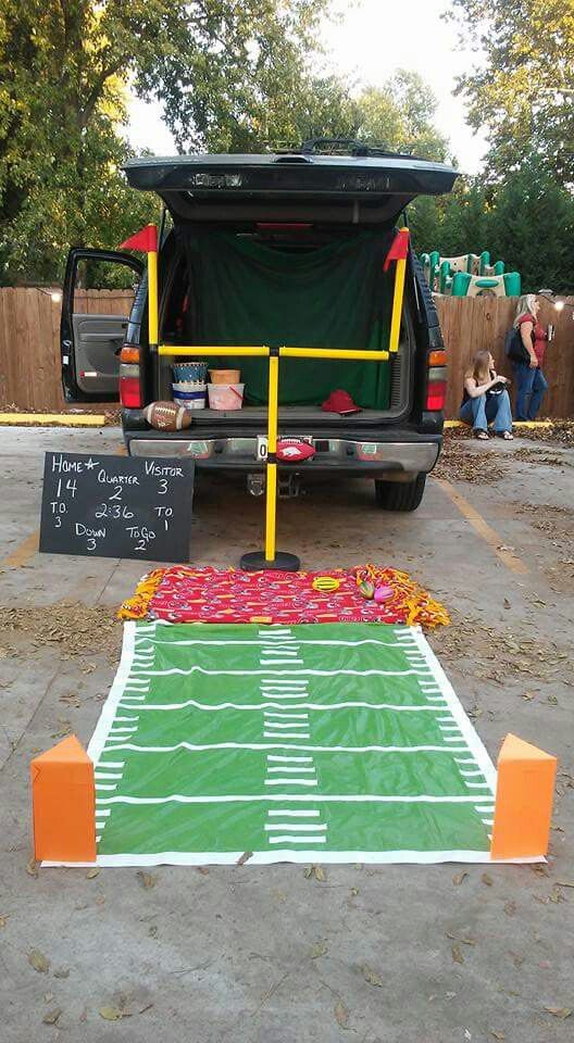 the back end of a vehicle with a football field on it and a chalkboard