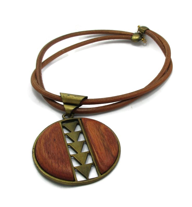 "DauplaIse Wood Brass Necklace Statement Necklace 18 Inches Long 18\" long and pendant is 3.5\" tall GOOD VINTAGE SHAPE Please visit my Etsy shop for other great vintage items TreasureTroveByTish.Etsy.com" Adjustable Large Pendant Necklace For Festivals, Brown Necklace With Adjustable Cord For Festivals, Adjustable Medallion Necklace With Large Pendant, Adjustable Brown Metal Necklace, Adjustable Brown Metal Necklaces, Vintage Necklace With Adjustable Cord For Festivals, Vintage Necklaces With Adjustable Length For Festivals, Adjustable Bronze Necklace With Large Pendant, Adjustable Brown Medallion Necklace