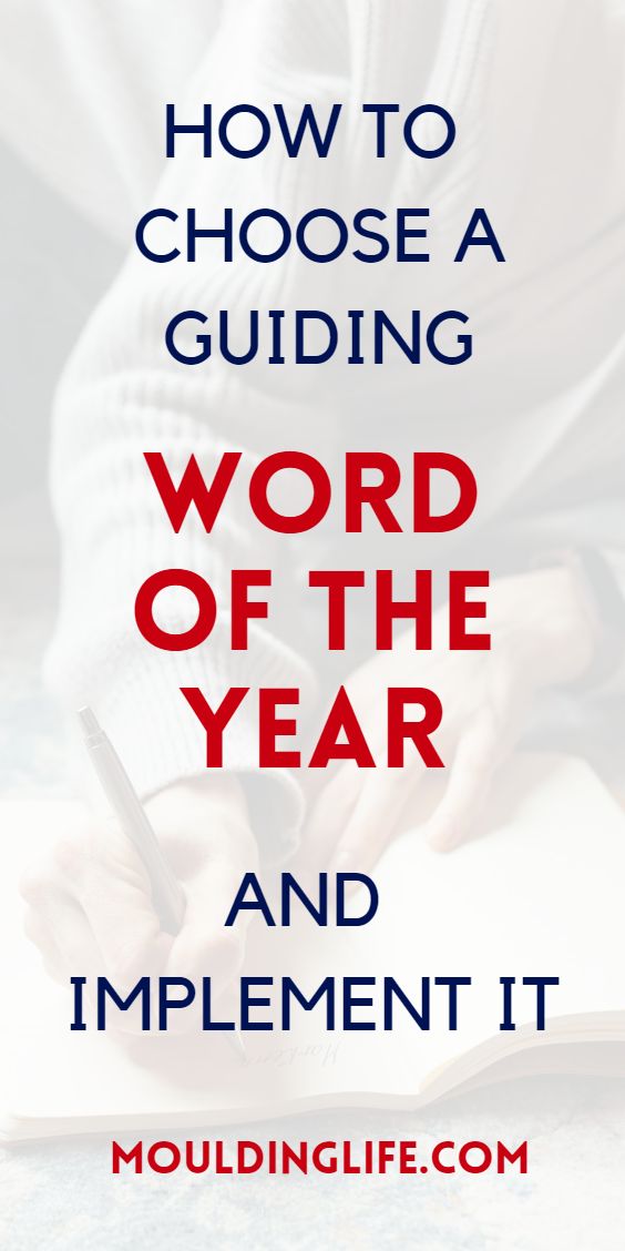 a person writing on a book with the words how to choose a guiding word of the year and implement it