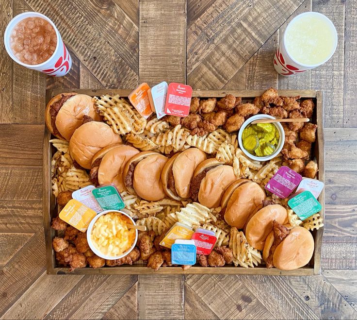 a wooden box filled with different types of food and drinks on top of a table