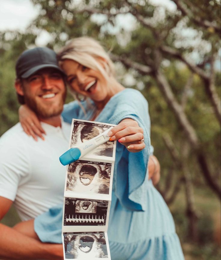 a man and woman are holding up an old photo with the same image on it