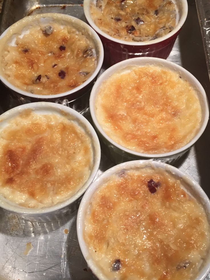 four cups filled with food sitting on top of a metal tray