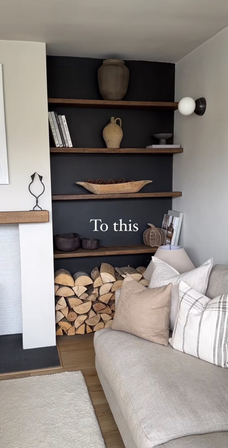 a living room filled with furniture and a fire place next to a wall mounted book shelf