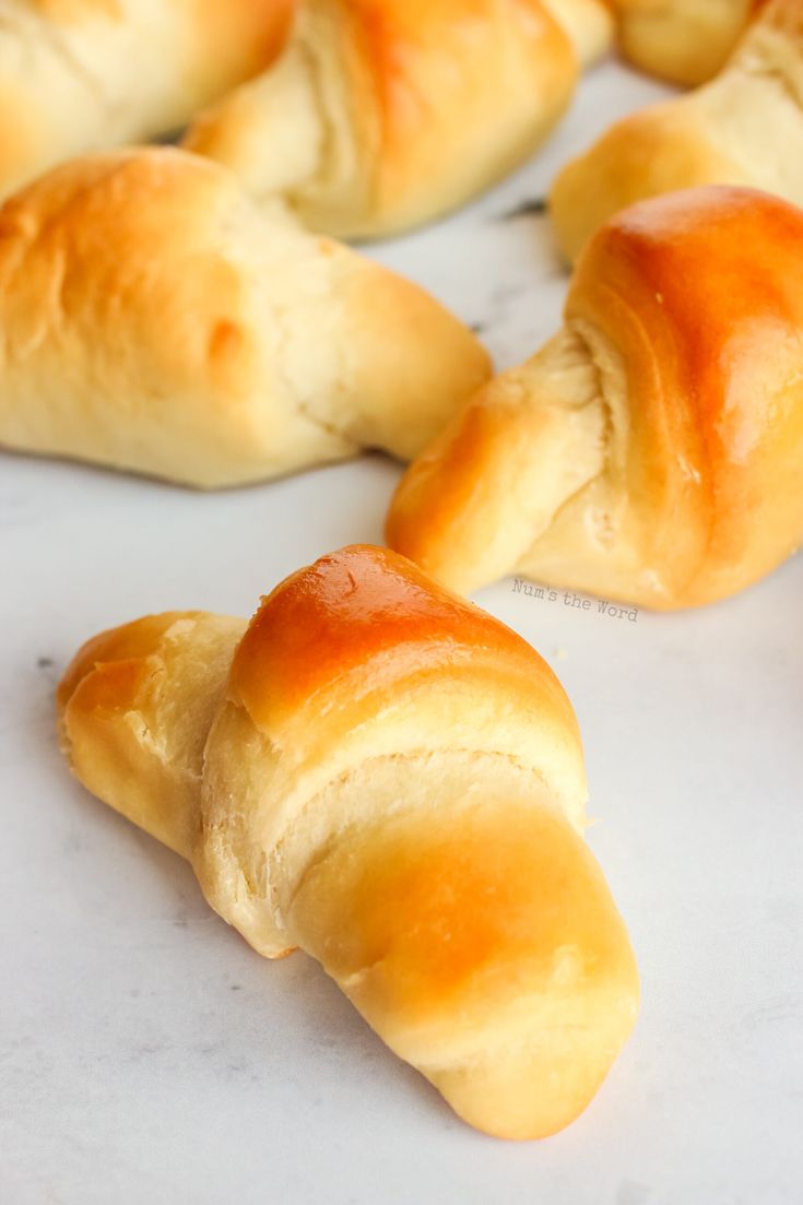 several croissants sitting on top of a white counter