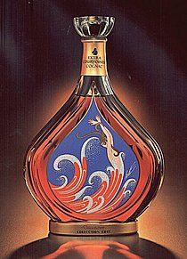 an advertisement for a perfume bottle with a lizard on it