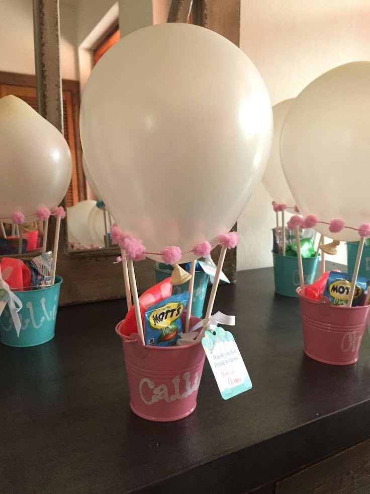 balloons and candy in buckets on a table