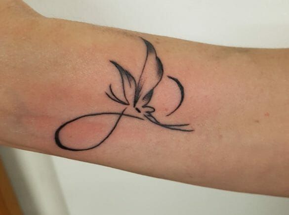 a tattoo on the arm of a woman with a bird flying over her shoulder,