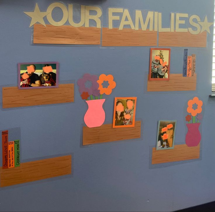 a wall that has pictures on it with flowers in vases and family photos attached to them