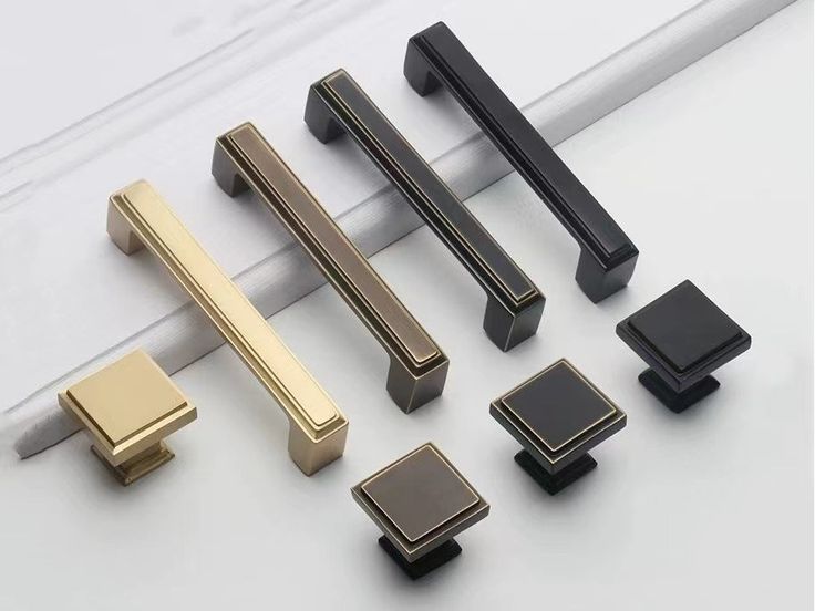 several different types of handles and pulls on a white surface, including one for the door