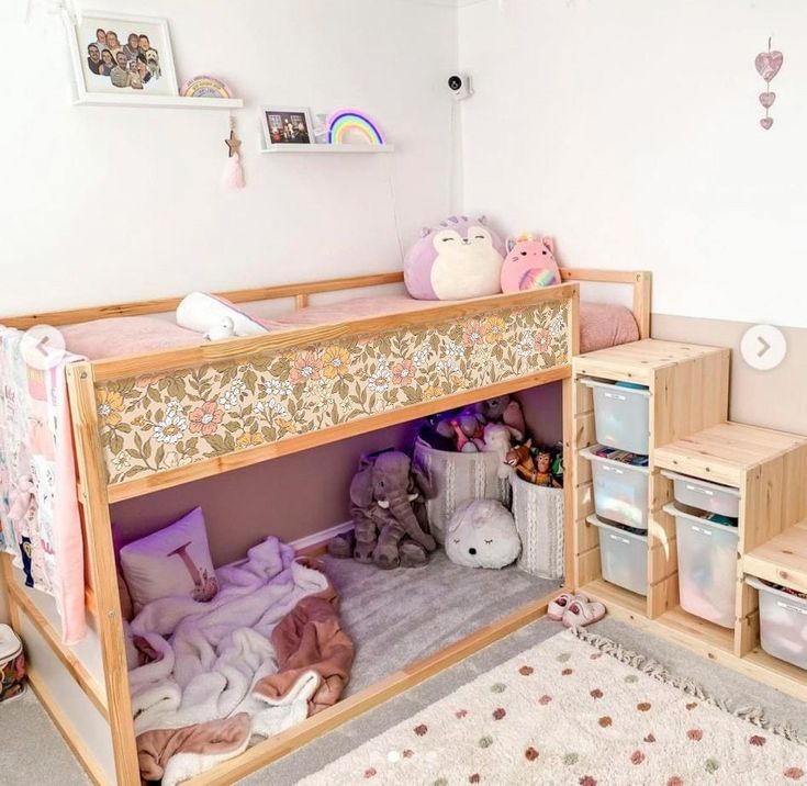 a child's room with a bunk bed and toy storage bins on the floor