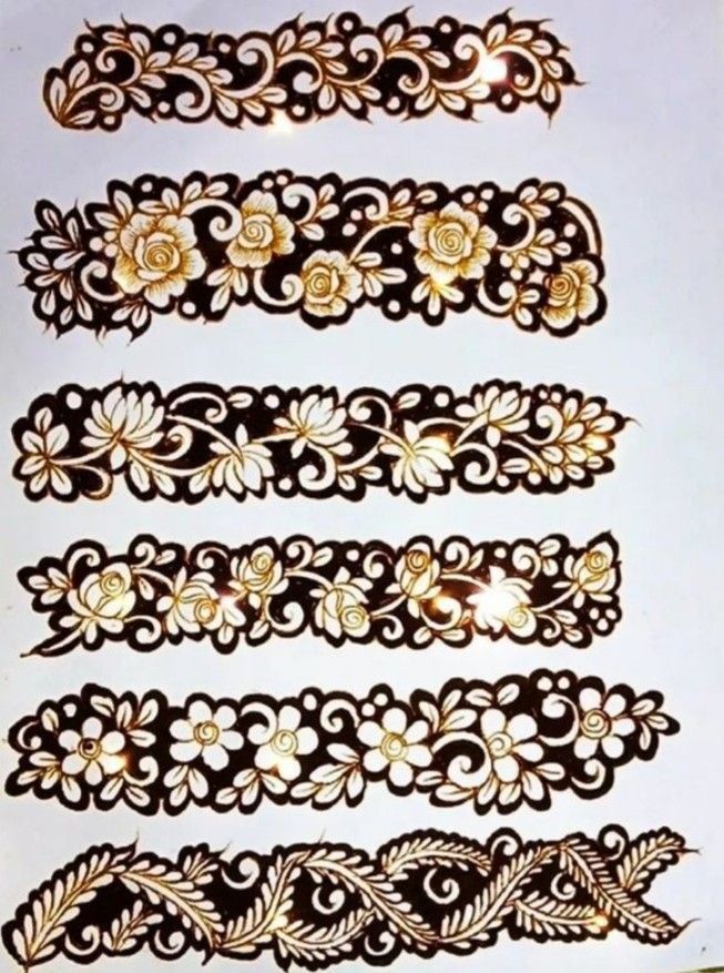 several different types of tattoos on a white sheet with gold trimmings and flowers