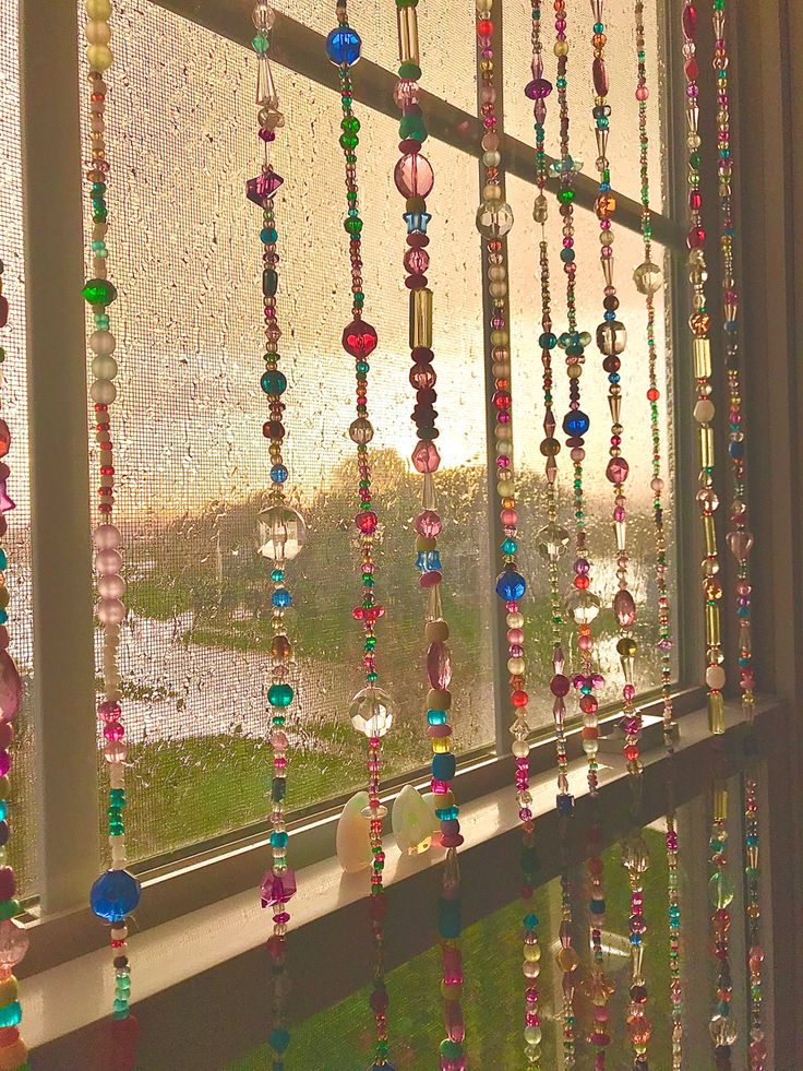 a window with beads hanging from it's side