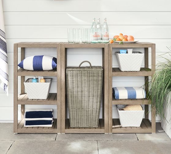 a shelf with baskets and towels on it