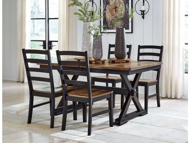 a dining room table with chairs and a vase