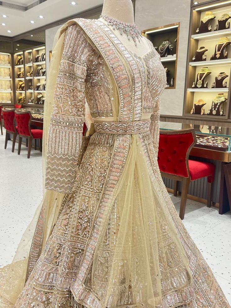 Look your best on your wedding day in this beautiful champagne bridal lehenga. The BL-158 is designed to help you shine with its gorgeous color and intricate details. A perfect combination of elegance and comfort. Fabric: Net with satin lining WASH CARE INSTRUCTIONS - Please Dry clean only when it is applicable. Ready to Ship! Elegant Semi-stitched Wedding Dress With Traditional Drape, Beige Anarkali Wedding Gown, Beige Anarkali Dress For Wedding, Floor-length Wedding Set With Resham Embroidery, Designer Gold Floor-length Dress, Gold Designer Floor-length Dress, Beige Wedding Dress With Intricate Embroidery, Designer Floor-length Gold Dress, Elegant Gold Floor-length Salwar Kameez